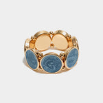 Elastiskt armband med runda plattor som har en guldkant i Blue