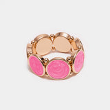 Elastiskt armband med runda plattor som har en guldkant i Pink