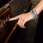 Strass Multi Row Bracelet in a dark background and snake ring